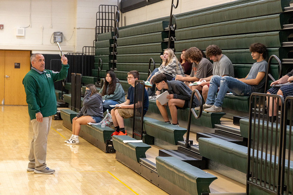 Image of students and teacher on bleachers