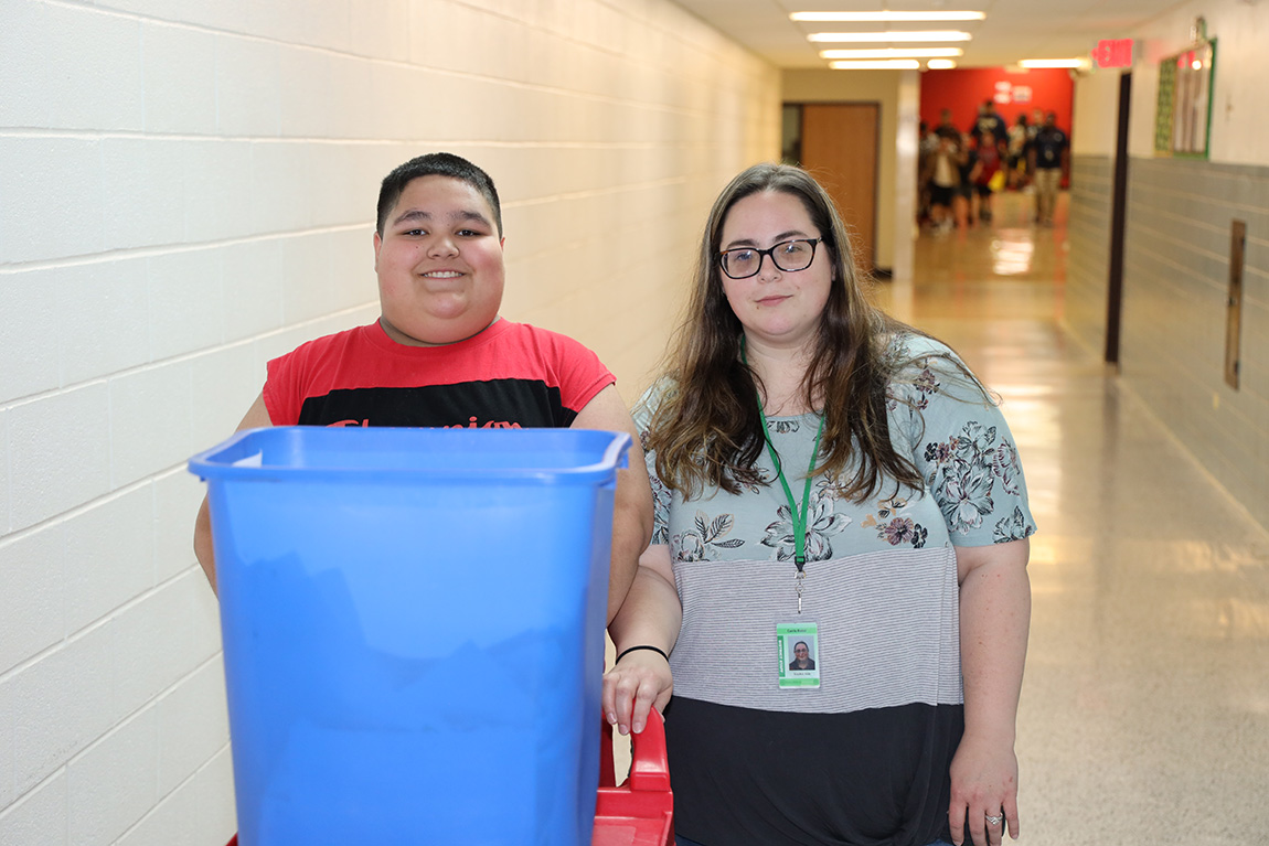 Image of staff member with student in hallway