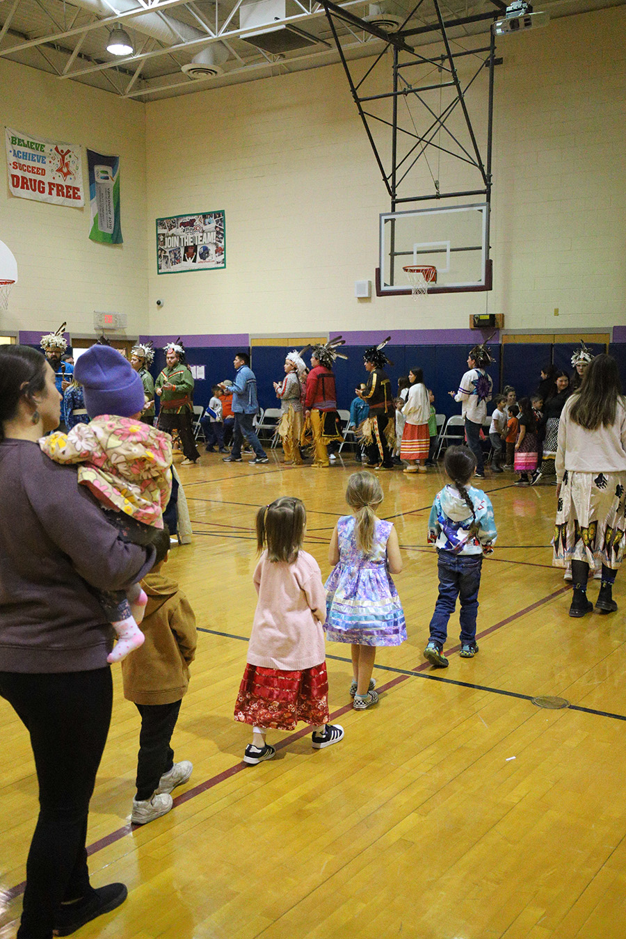 Image of students walking in a line during a school event.