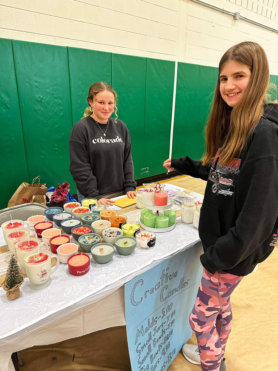 Image of two students selling candles