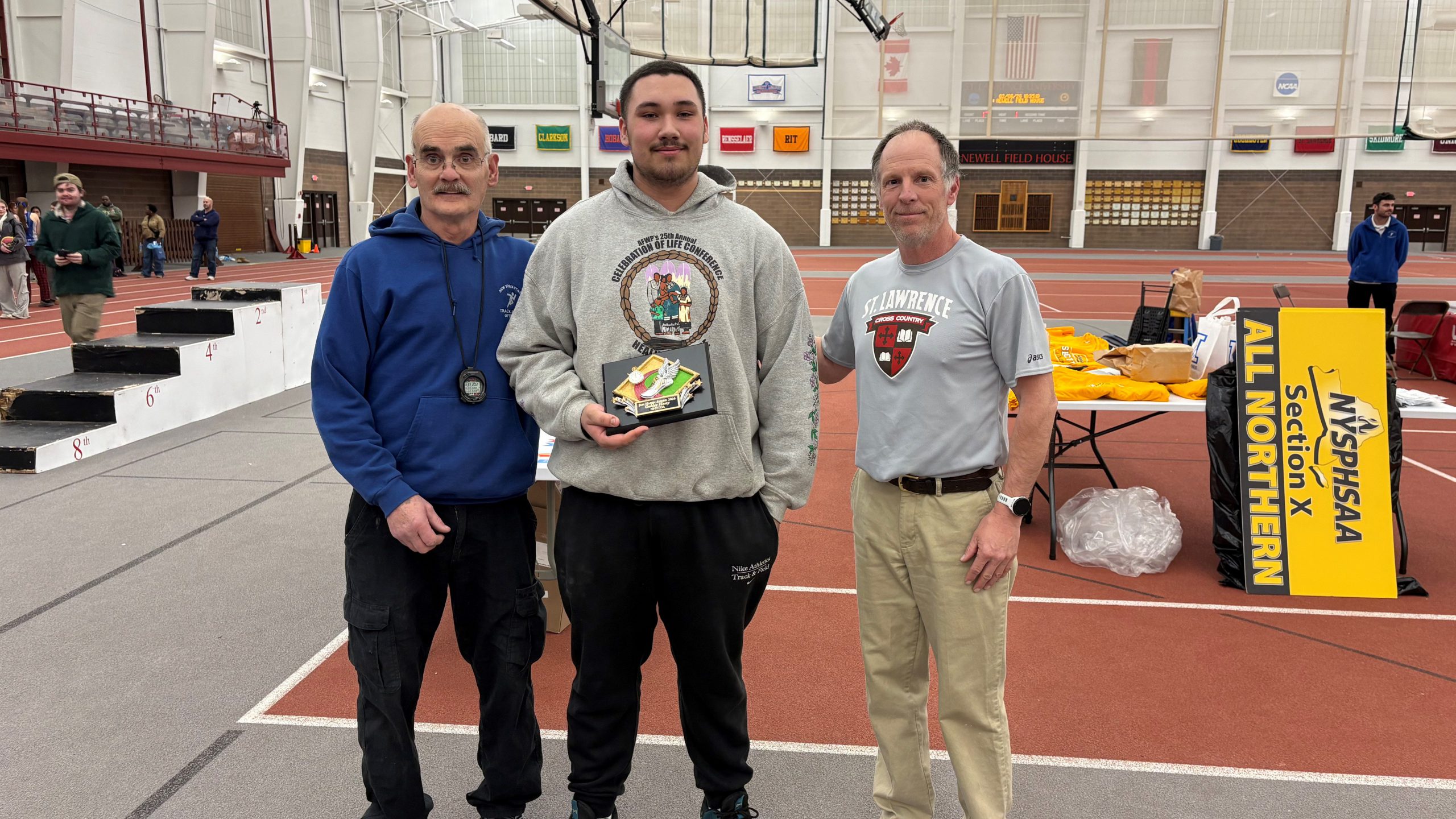 Oakly smiles holding prestigious award.
