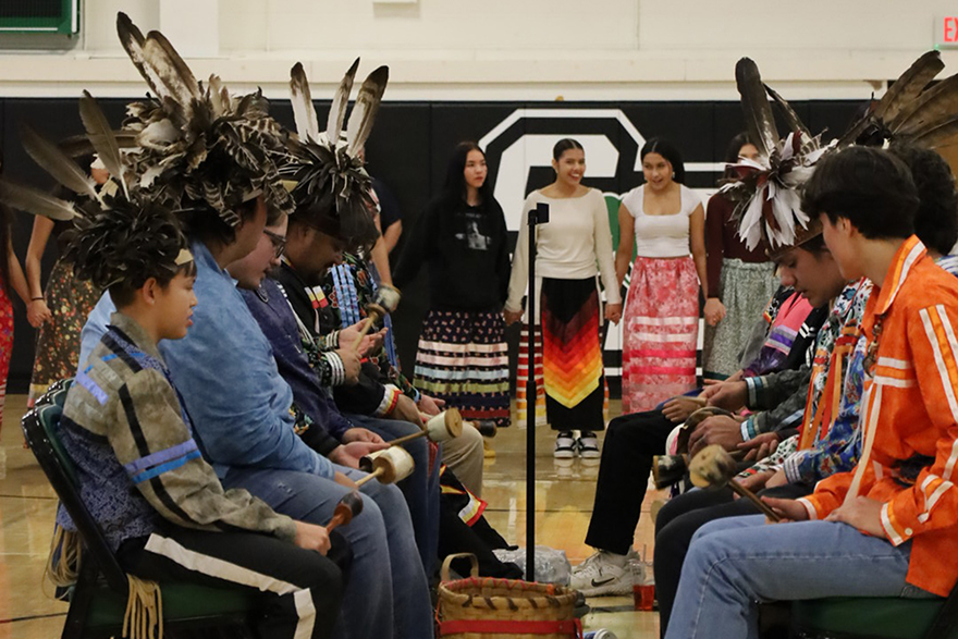 Students partaking in Native Day wearing traditional feather headdress